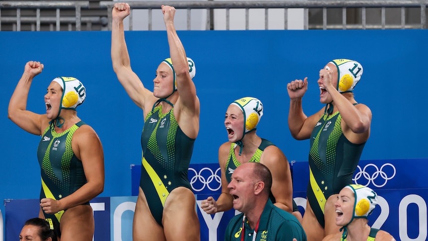 Australia's women's water polo team celebrates poolside against the Netherlands.