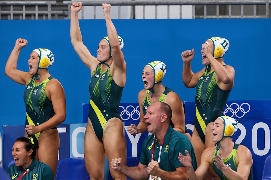 Australia's women's water polo team celebrates poolside against the Netherlands.