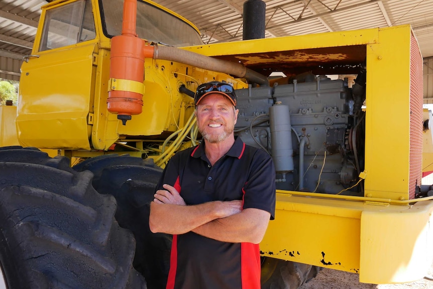 Farmer Colin Penny standing in front of a modified tractor