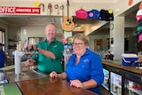 Two people serving beer in a country pub.