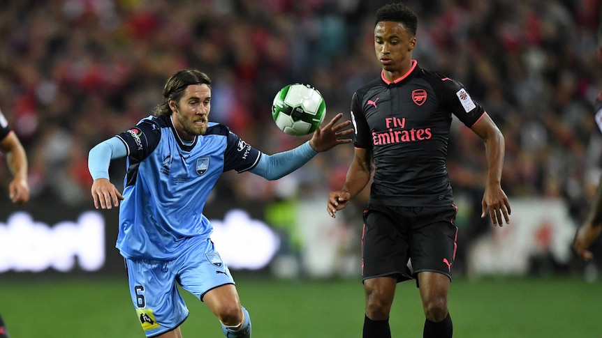 Joshua Brillante and Cohen Brammall look at the ball as they contest for possession.