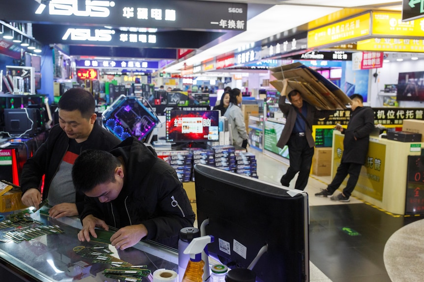 Men at an electronics store.