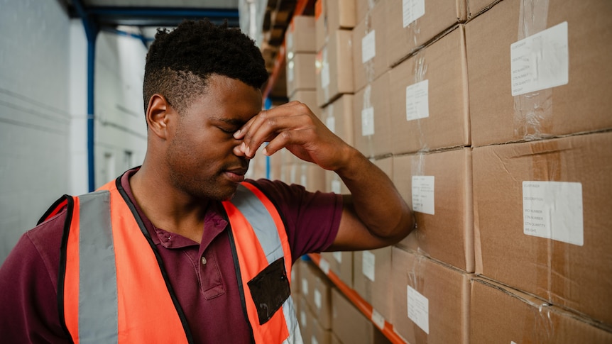 Stressed worker wearing high vis