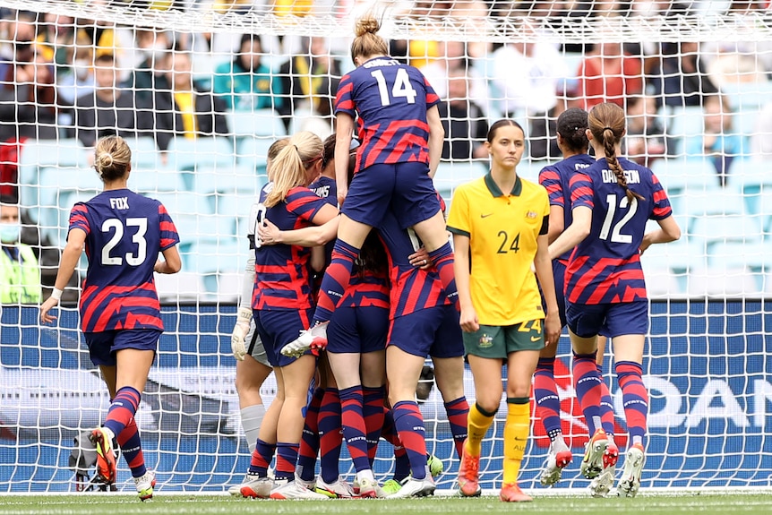 USA celebrate after scoring a goal against the Matildas