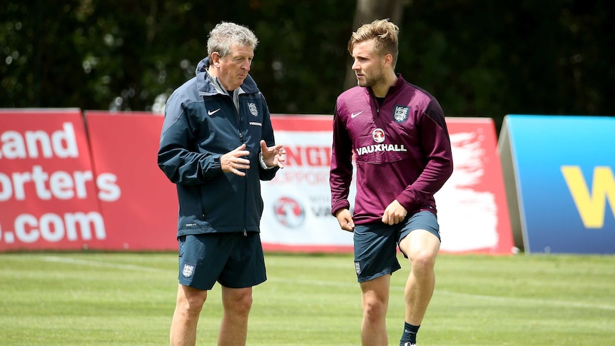 Manager Roy Hodgson talks with Luke Shaw at England's pre-World Cup camp in Portugal in May 2014.