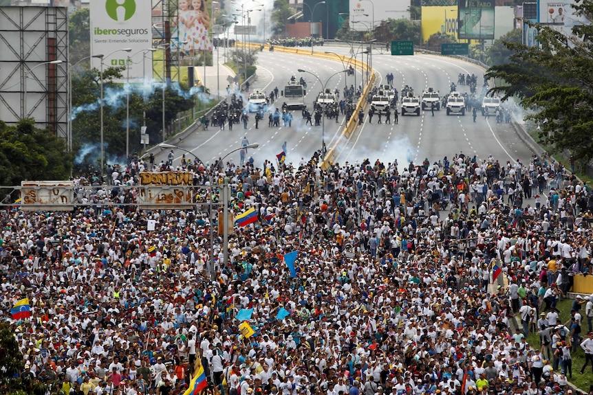 Demonstrators clash with riot police during the 'mother of all marches' in Caracas, Venezuela.