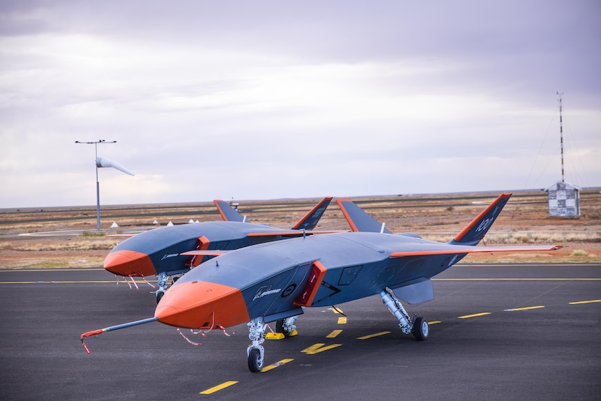 Two red and grey military drones. 