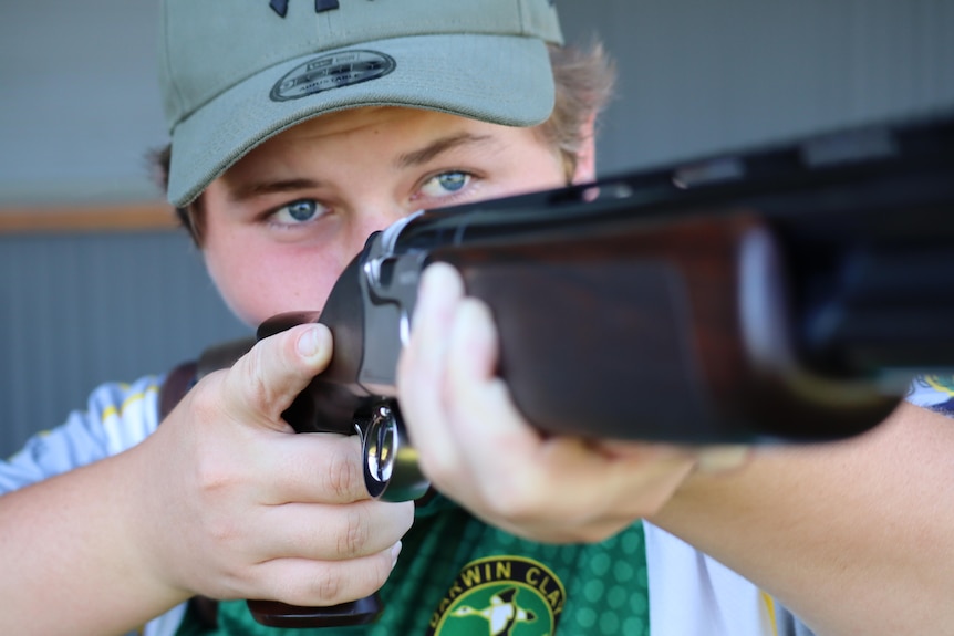 A close up shot of Les Harris aiming his gun.