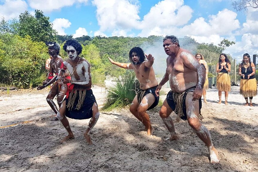 Four men traditional owners the Butchulla people celebrate in traditional costume on Fraser Island.