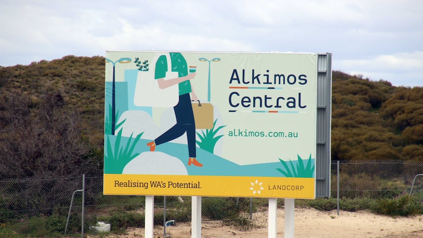 A sign advertising Alkimos Central sits on a large area of vacant land.