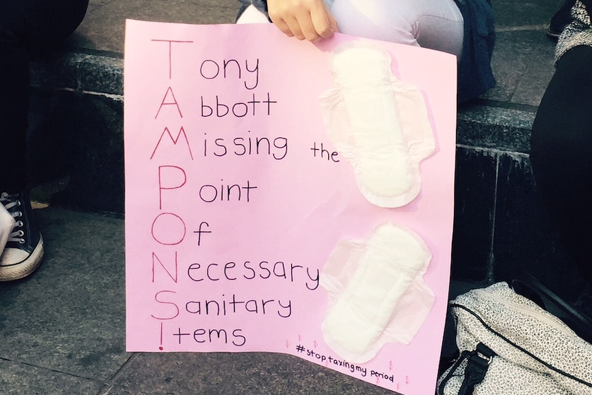 Woman holds sign at rally