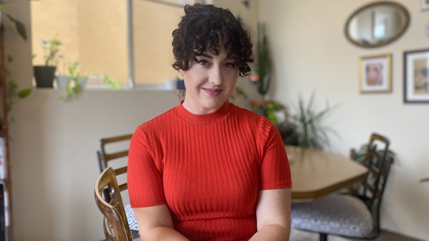 Erinenne Lette sits in her Sydney living room. 