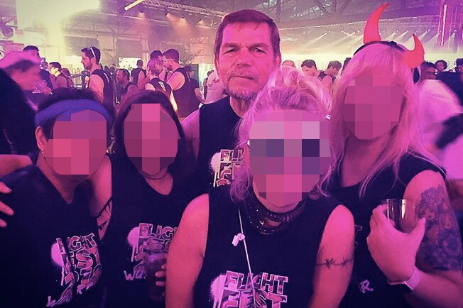 Four pixelated Flight Centre staff members with Graham Turner at a party.