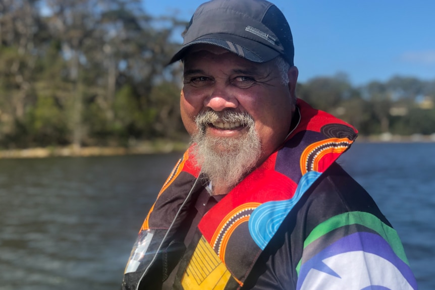 Wally Stewart portrait smiling standing on boat