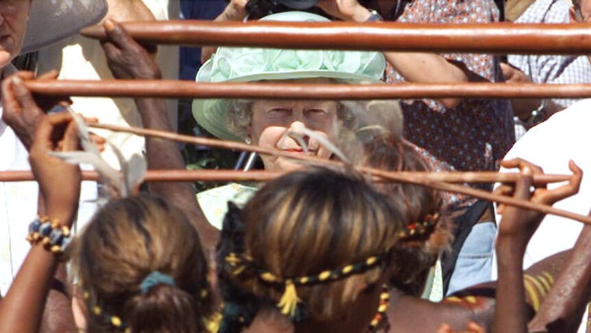 Queen Elizabeth watches as Aboriginal women dance.