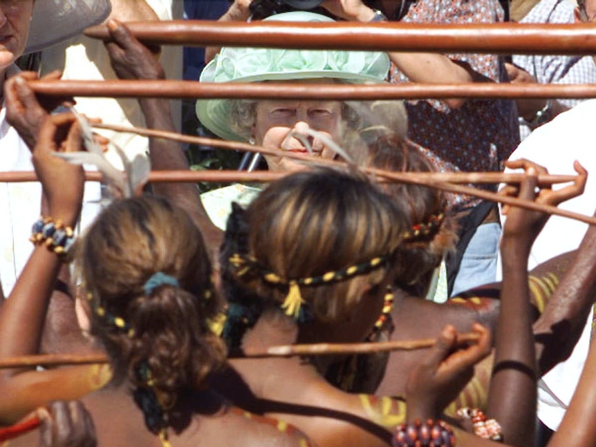 Queen Elizabeth watches as Aboriginal women dance.