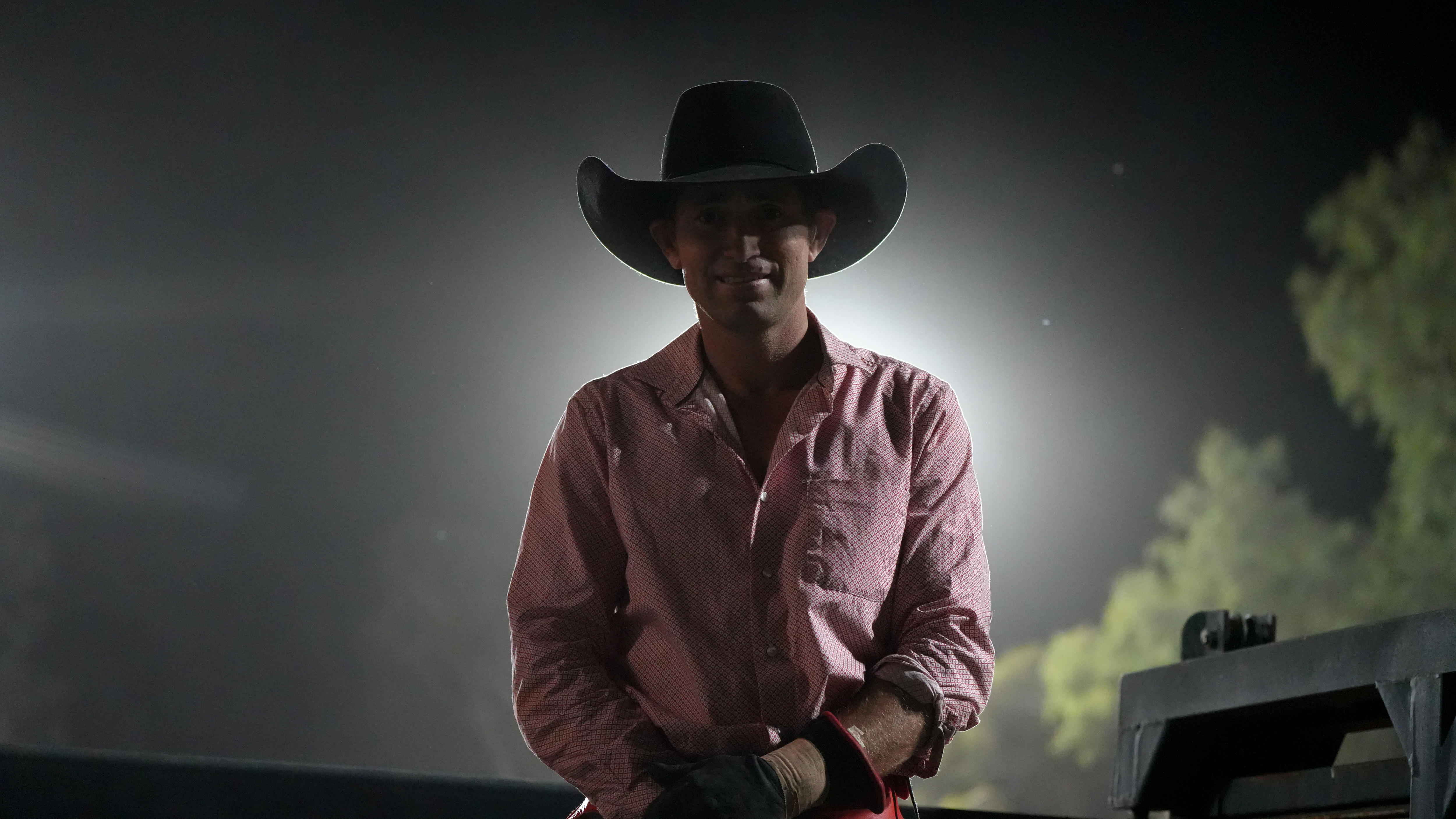 A back-lit picture of a cowboy