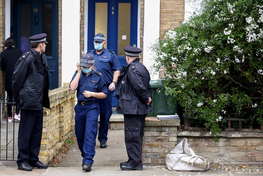 Police and detectives outside a house in London.