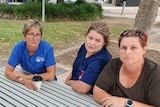 Four hospital nurses sitting around a park bench to tell their stories about working throughout the pandemic. Gosford NSW 2022