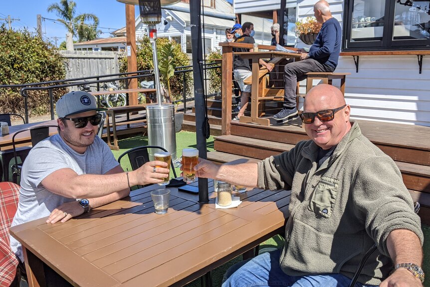 Two men enjoy a beer at a Torquay pub.