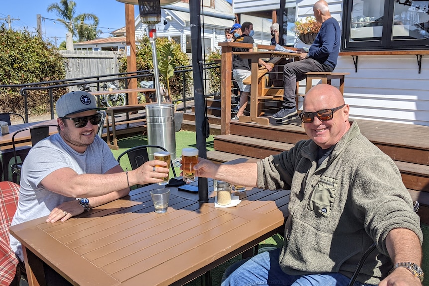 Two men enjoy a beer at a Torquay pub.