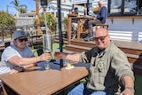 Two men enjoy a beer at a Torquay pub.