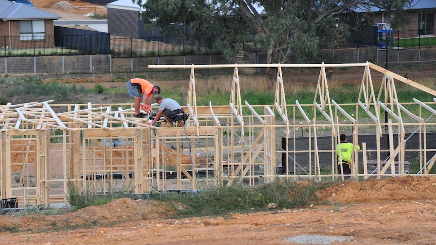 Workers on a house being built