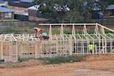 Workers on a house being built