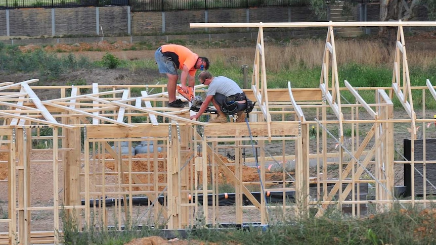 Workers on a house being built