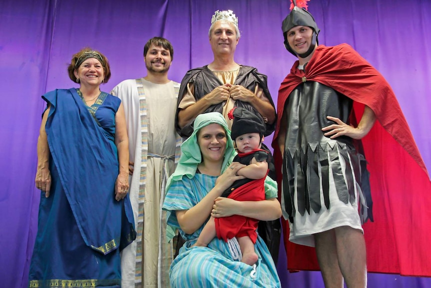 A family dressed up in period costume as part of a recreation of the bible story of the birth of Jesus