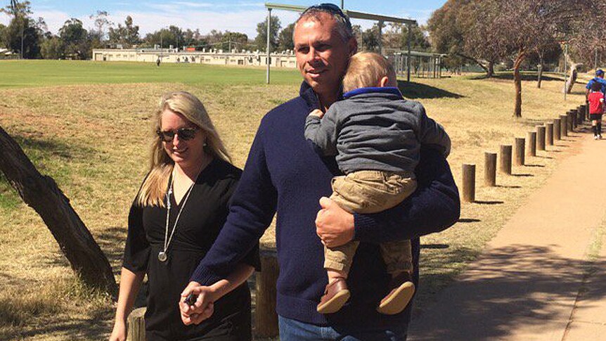 Adam Giles walks to the Braitling polling booth with partner Phoebe Stewart and son Robert.