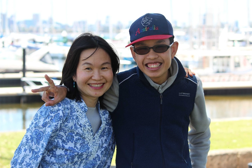 Mother and son in front of boat harbour