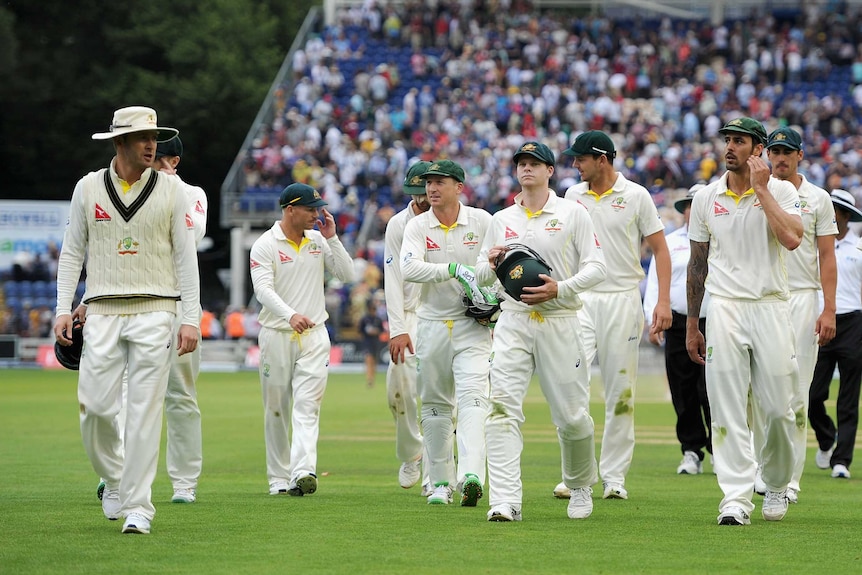 Michael Clarke leads Australia off after day three of the first Ashes Test at Sophia Gardens