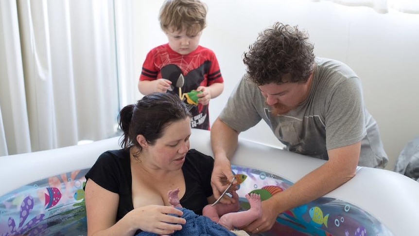 Sara's partner cuts the cord of her newborn baby during the free birth.