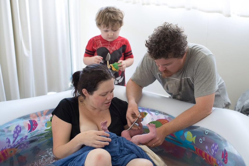 Sara's partner cuts the cord of her newborn baby during the free birth.