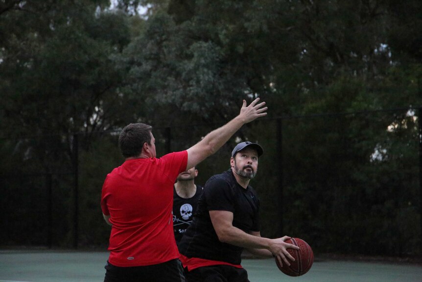 Ed Husic looks to take a shot in a politicians' basketball game.