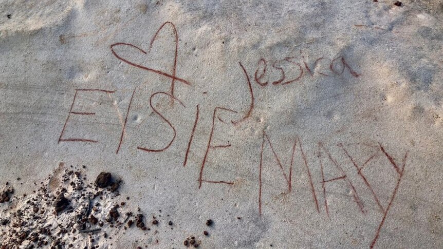 Names and love hearts scrawled onto rocks 