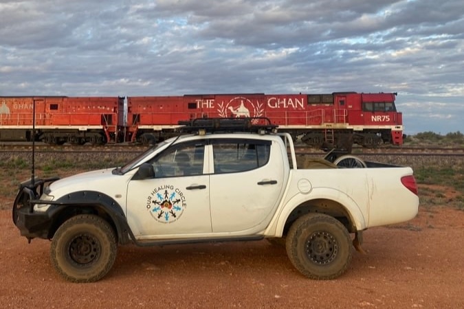 An addiction Australia ute in front of the Ghan train
