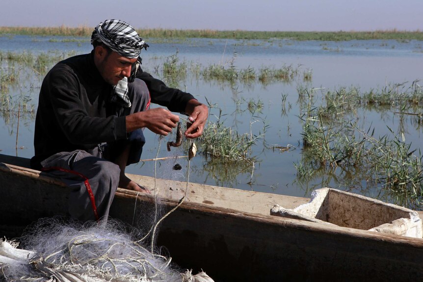 A fisherman checks his nets