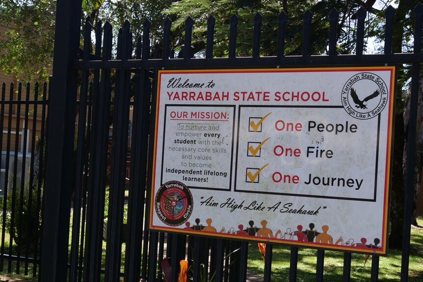a sign for Yarrabah state school on a fence