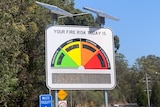 an electronic fire danger rating sign on the side of a rural road