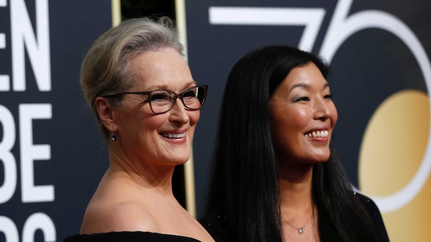 Actress Meryl Streep and the director of the National Domestic Workers Alliance, Ai-jen Poo both smiling and wearing black dress