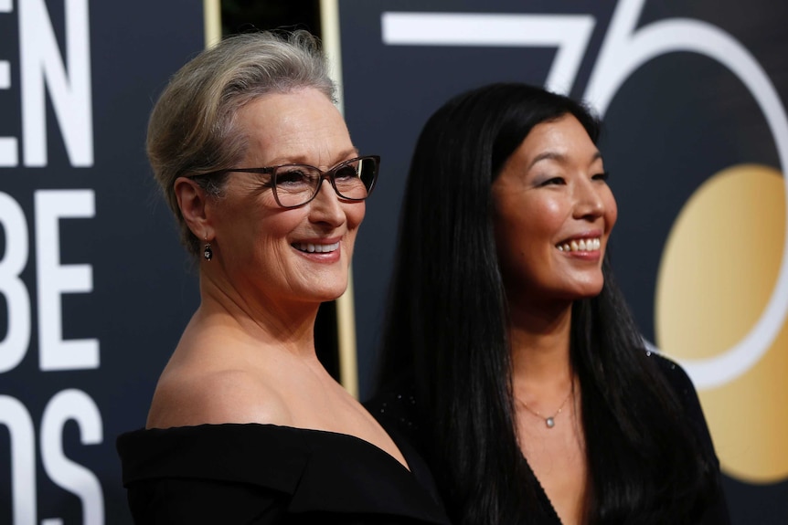 Actress Meryl Streep and the director of the National Domestic Workers Alliance, Ai-jen Poo both smiling and wearing black dress