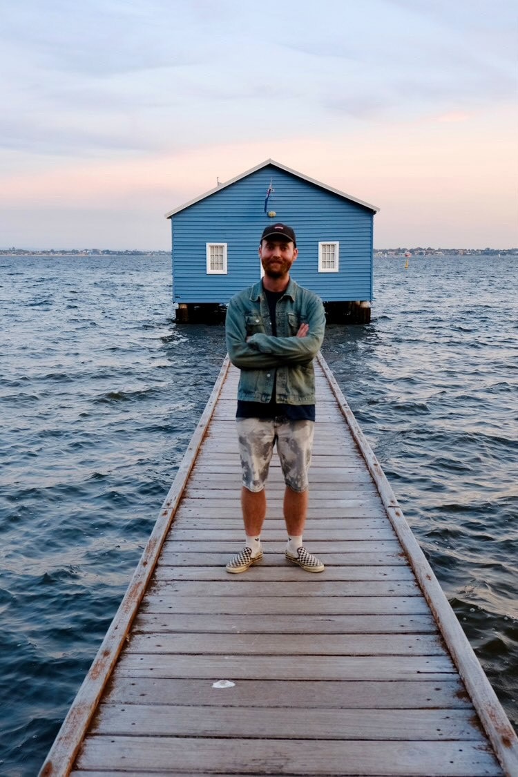 Charlie Wade stands on a pier