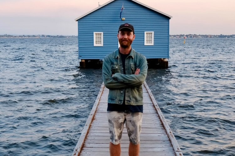 Charlie Wade stands on a pier