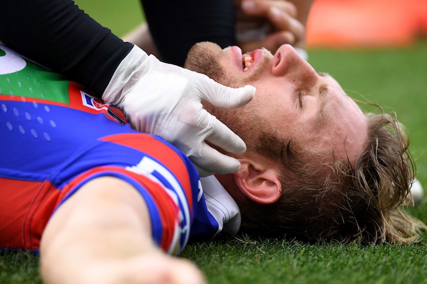 Brendan Elliot lies on the ground against the Rabbitohs