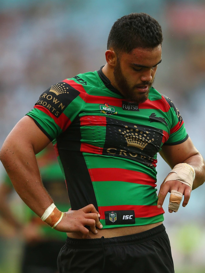 South Sydney's Dylan Walker looks at his injured hand against Wests Tigers