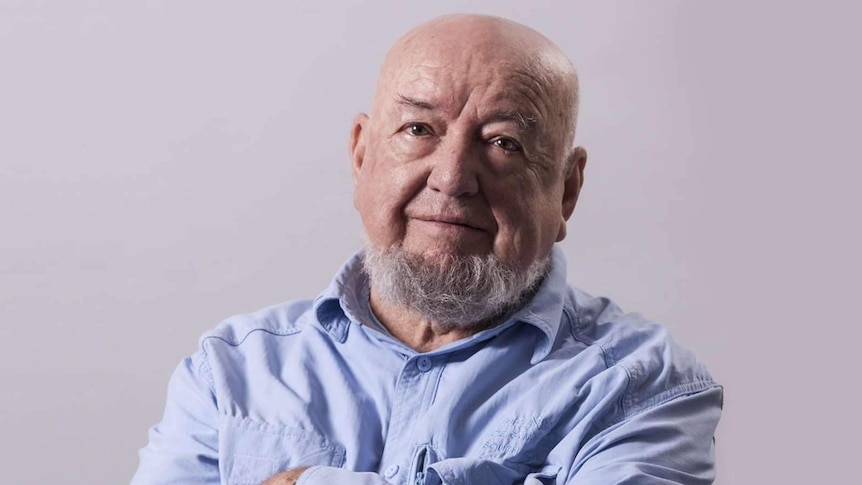 Tom Keneally  looks at the camera