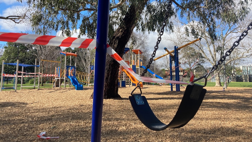 A child's swing in the park wrapped up in tape.