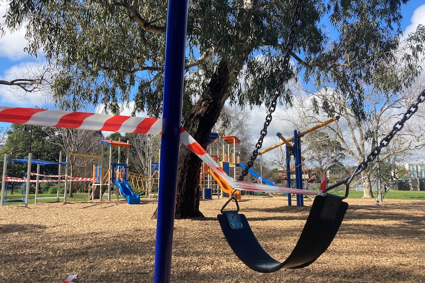 A child's swing in the park wrapped up in tape.